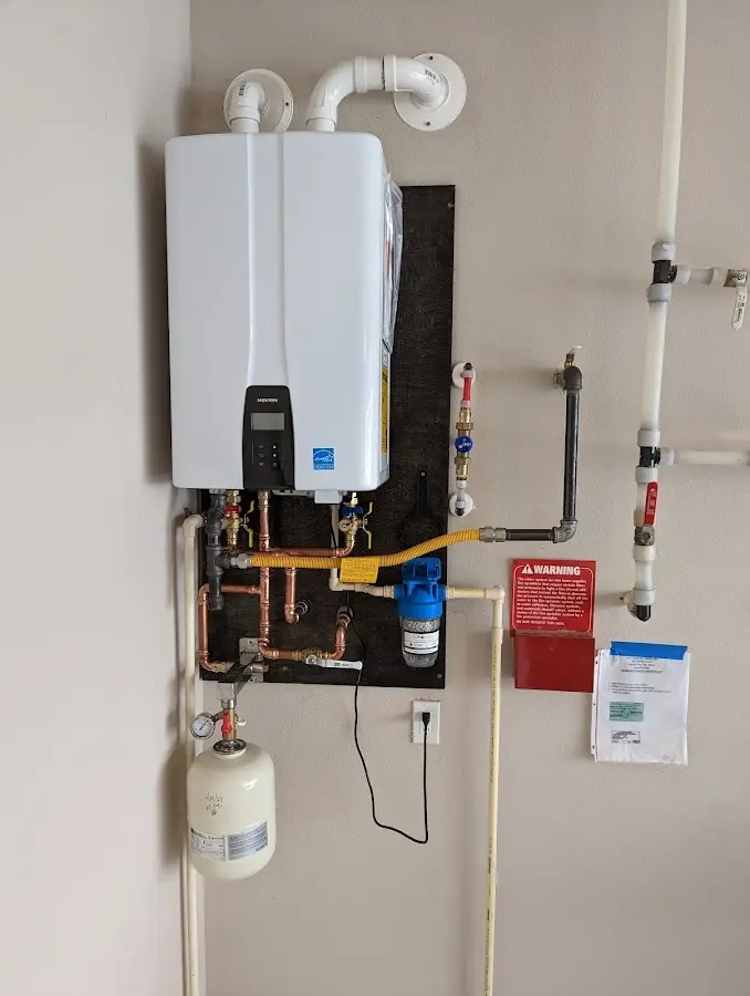 Professional plumber installing copper piping in a Dinuba home